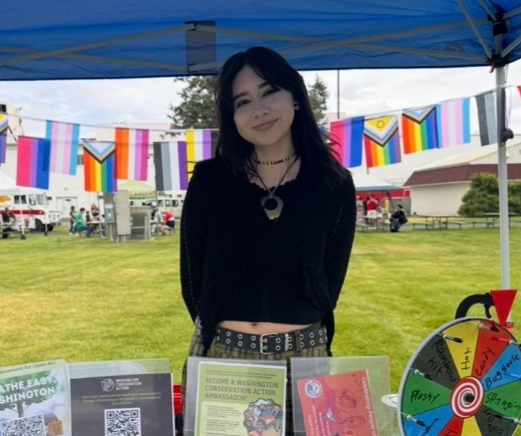 Karina Solorio, WCA Yakima Community Organizer, tables at a community event.